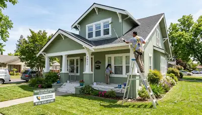 Professional house painters working on residential exterior in Sacramento, CA